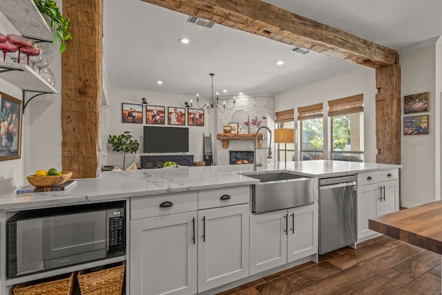 147 Rim Rock Rd, Aledo, TX 76008 - kitchen with black microwave, stainless steel dishwasher, a sink, a chandelier, and white cabinets