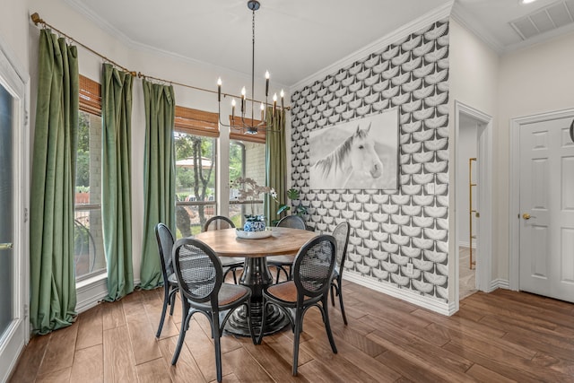 147 Rim Rock Rd, Aledo, TX 76008 - dining space with wood finished floors, ornamental molding, a chandelier, an accent wall, and baseboards