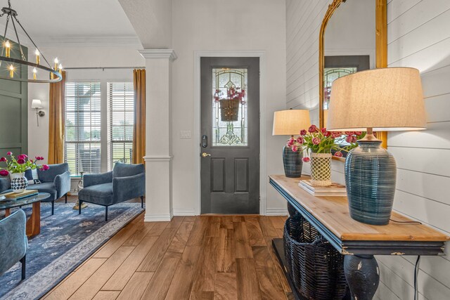 147 Rim Rock Rd, Aledo, TX 76008 - foyer with ornate columns, crown molding, wood finished floors, a chandelier, and baseboards