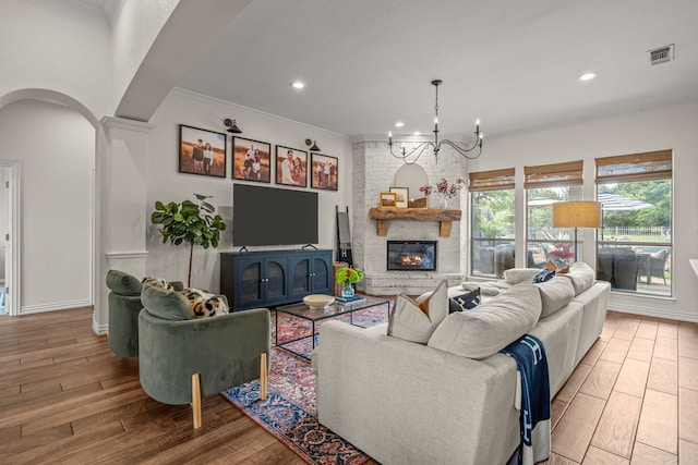 147 Rim Rock Rd, Aledo, TX 76008 - living area featuring wood finished floors, recessed lighting, arched walkways, ornamental molding, and a chandelier