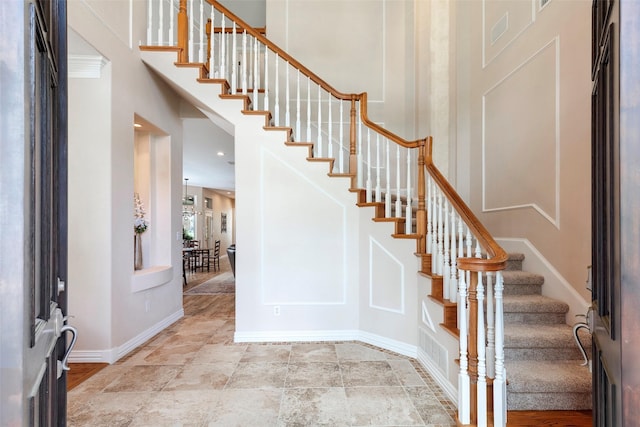 1413 Hunters Ridge Cir, Denton, TX 76205 - foyer entrance with stairway, baseboards, and a towering ceiling