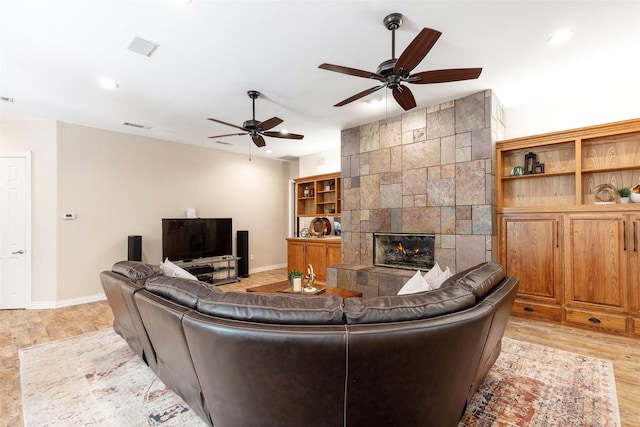 1413 Hunters Ridge Cir, Denton, TX 76205 - living area featuring a ceiling fan, light wood-style flooring, baseboards, a tile fireplace, and recessed lighting