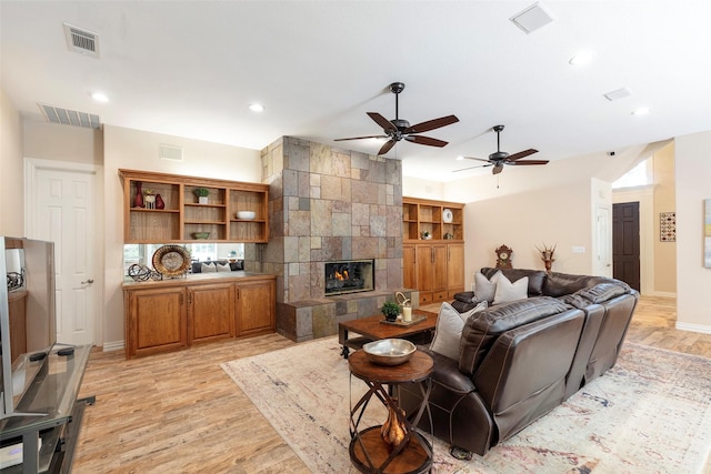 1413 Hunters Ridge Cir, Denton, TX 76205 - living room with light wood-type flooring, recessed lighting, a ceiling fan, a tiled fireplace, and baseboards