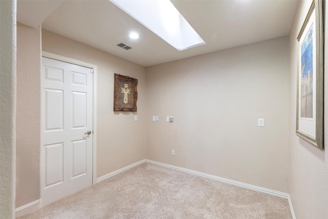 1413 Hunters Ridge Cir, Denton, TX 76205 - spare room featuring carpet flooring, a skylight, and baseboards