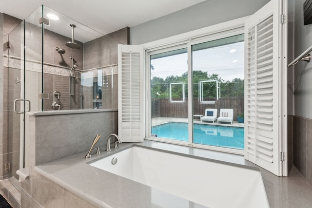 bathroom featuring a stall shower and a garden tub