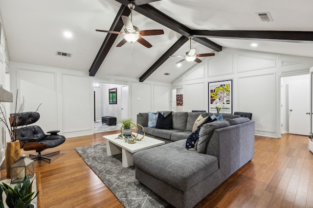 living room featuring a decorative wall, a ceiling fan, and wood-type flooring