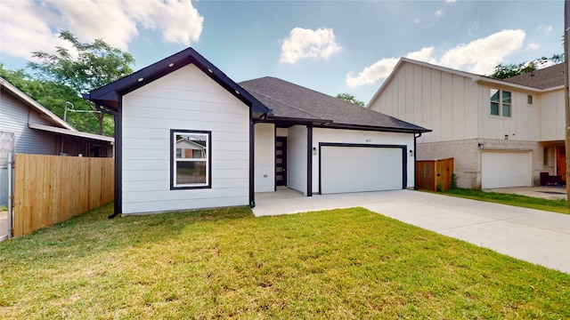 402 Perry Ave, Waxahachie, TX 75165 - view of front of house with driveway, a garage, board and batten siding, and roof with shingles