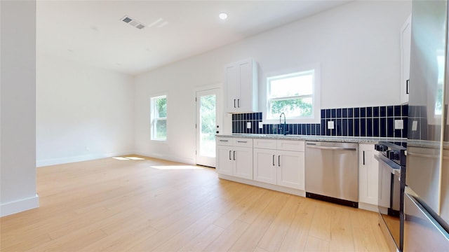 402 Perry Ave, Waxahachie, TX 75165 - kitchen featuring dishwasher, decorative backsplash, healthy amount of natural light, light wood-style floors, and recessed lighting