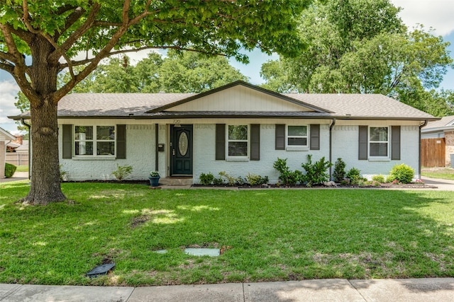 single story home with roof with shingles and brick siding