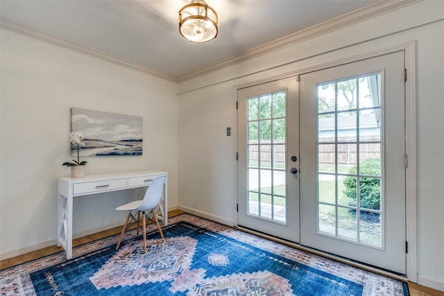 entryway with french doors, crown molding, wood finished floors, baseboards, and a desk