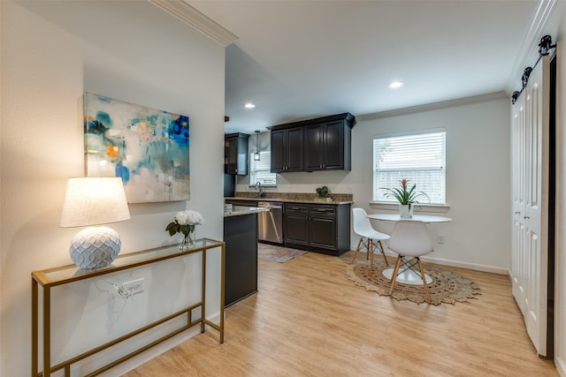kitchen featuring stainless steel dishwasher, ornamental molding, light wood-style floors, plenty of natural light, and light stone countertops
