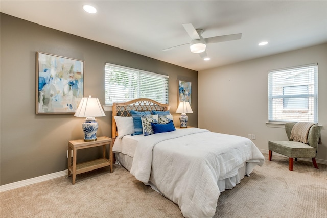 bedroom featuring multiple windows, light carpet, recessed lighting, and baseboards