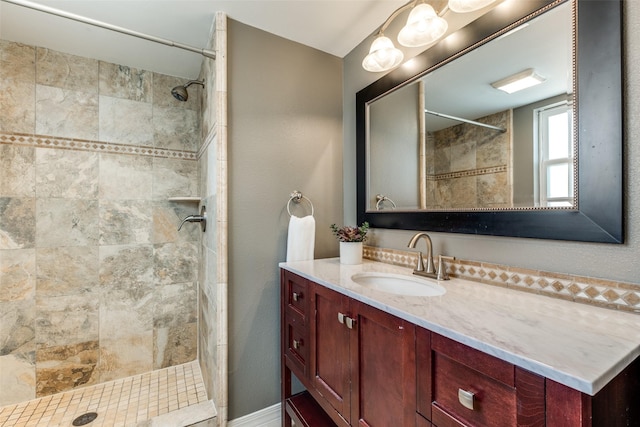 full bathroom featuring vanity and a tile shower