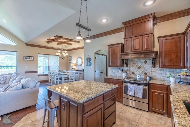 kitchen featuring electric stove, crown molding, open floor plan, tasteful backsplash, and a center island