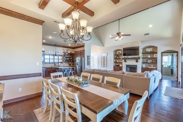 dining area featuring ceiling fan, a fireplace, a chandelier, plenty of natural light, and recessed lighting