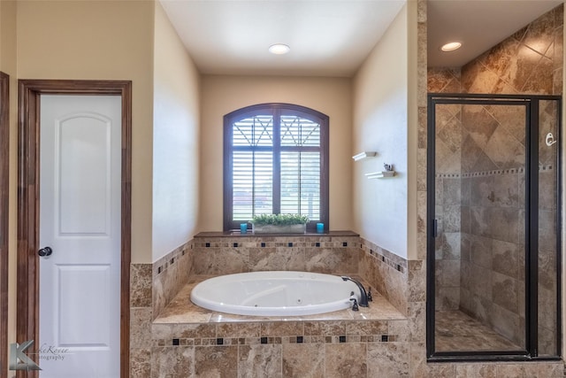 bathroom featuring a shower stall, a jetted tub, and recessed lighting