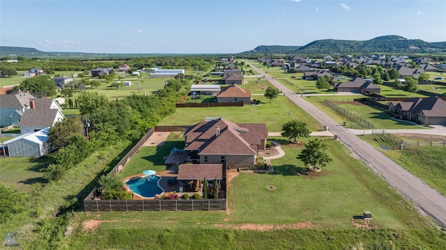 aerial view of residential area with a pool and a mountain backdrop