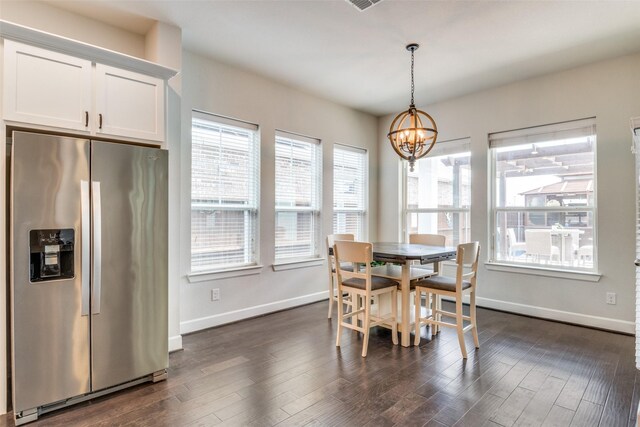 dining space with a chandelier, baseboards, and dark wood-style floors