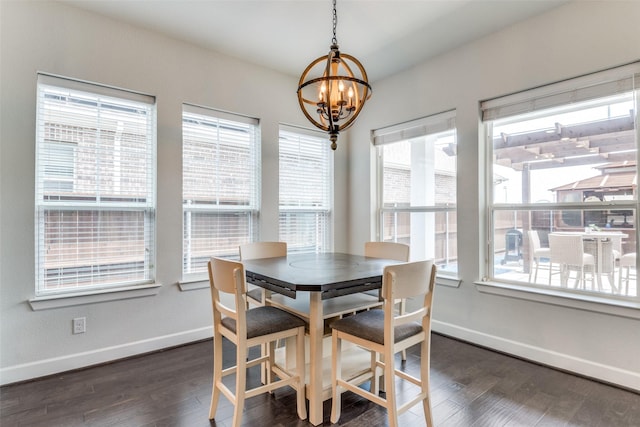 dining area with a chandelier, baseboards, and dark wood finished floors