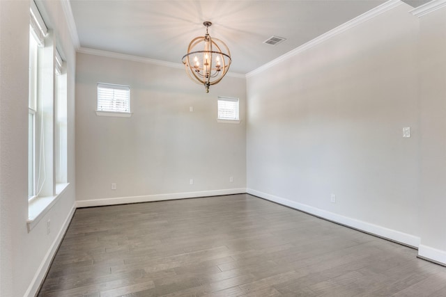 spare room with crown molding, a chandelier, dark wood-style floors, and baseboards