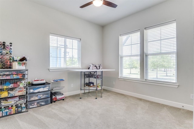 recreation room with a ceiling fan, carpet floors, and baseboards