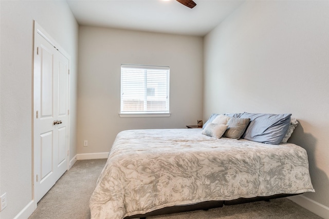 bedroom featuring light carpet and baseboards
