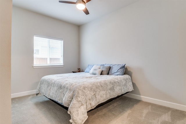 carpeted bedroom with baseboards and ceiling fan