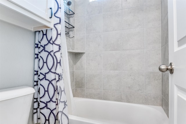 bathroom with shower / bath combo and toilet