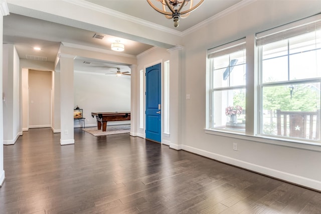 foyer entrance with crown molding, dark wood-type flooring, baseboards, and decorative columns