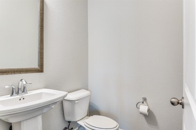 bathroom featuring toilet and a sink