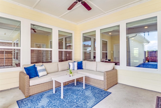 sunroom featuring ceiling fan and an outdoor living space