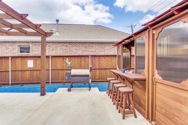view of patio featuring fence and a pergola