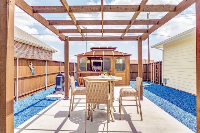 view of patio / terrace featuring a gazebo, a pergola, a fenced backyard, and outdoor dining space