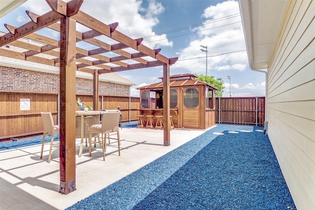 view of patio / terrace featuring a pergola, a gazebo, outdoor dining area, and a fenced backyard
