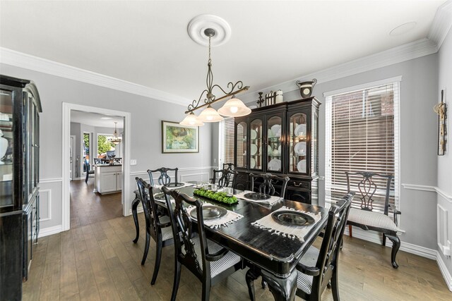 2631 Valley Creek Trl, Mckinney, TX 75072 - dining area featuring ornamental molding, hardwood / wood-style floors, wainscoting, and a decorative wall