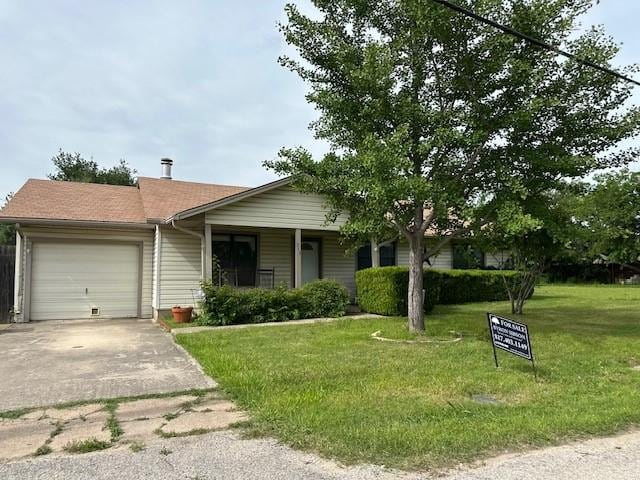 ranch-style home featuring a garage, a front yard, and asphalt driveway