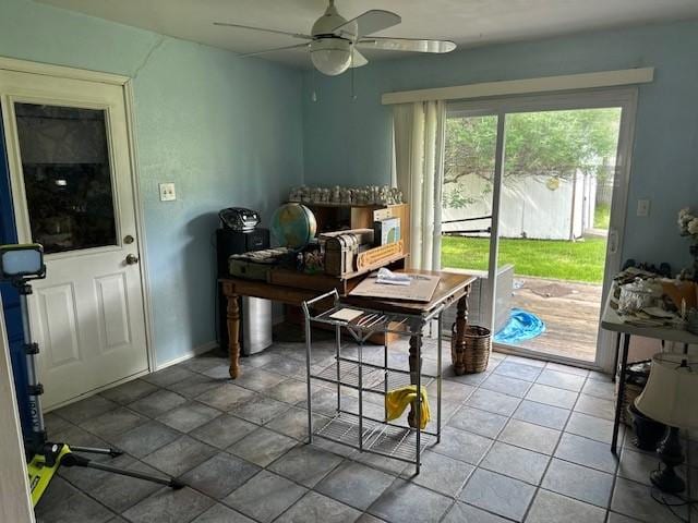 office space with ceiling fan and baseboards