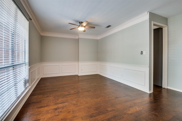 6308 Bittersweet Dr, Arlington, TX 76001 - empty room featuring plenty of natural light, a ceiling fan, crown molding, a wainscoted wall, and dark wood-style floors