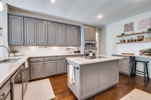 6308 Bittersweet Dr, Arlington, TX 76001 - kitchen featuring gray cabinetry, appliances with stainless steel finishes, light stone counters, open shelves, and backsplash