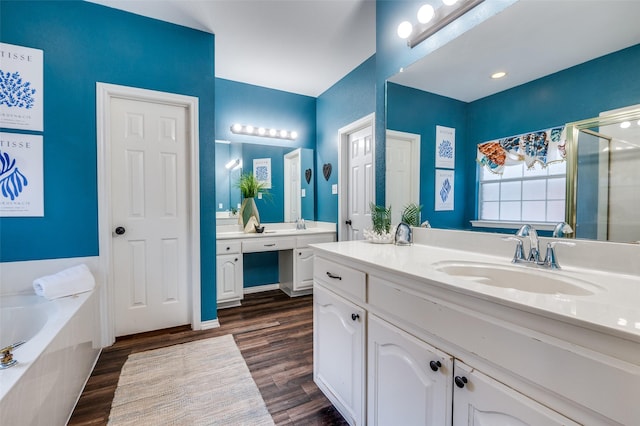6308 Bittersweet Dr, Arlington, TX 76001 - bathroom with wood finished floors, a stall shower, a bath, and vanity