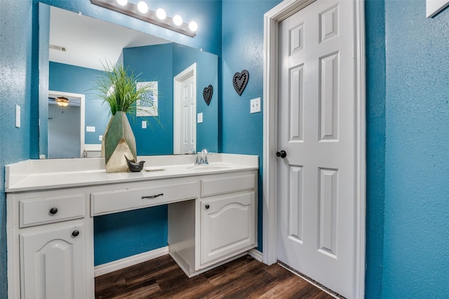 6308 Bittersweet Dr, Arlington, TX 76001 - bathroom with wood finished floors, a textured wall, vanity, and a ceiling fan