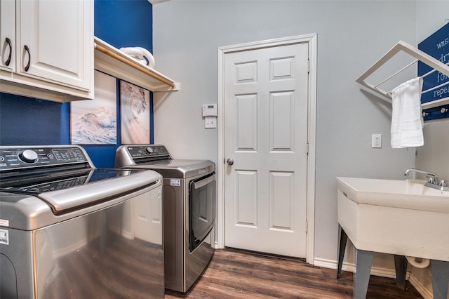 6308 Bittersweet Dr, Arlington, TX 76001 - laundry room with cabinet space, washing machine and clothes dryer, and dark wood-type flooring