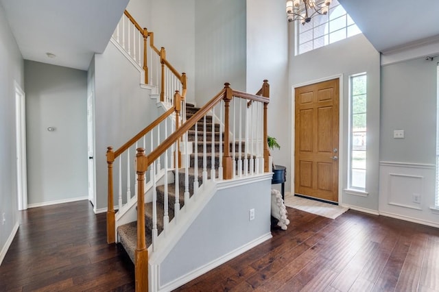 6308 Bittersweet Dr, Arlington, TX 76001 - foyer entrance featuring hardwood / wood-style floors, a chandelier, stairs, a towering ceiling, and baseboards