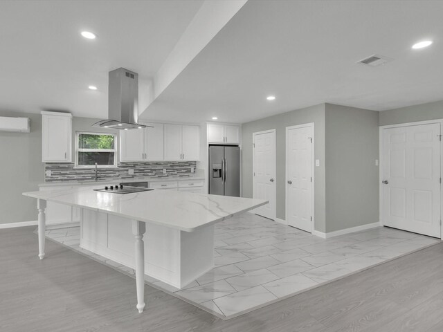 2834 Sunny Hill Ln, Farmers Branch, TX 75234 - kitchen with stainless steel refrigerator with ice dispenser, island exhaust hood, black electric stovetop, an AC wall unit, and baseboards