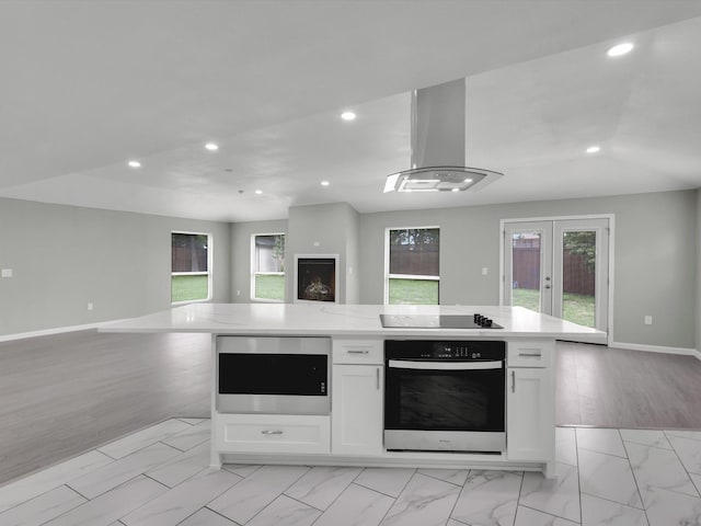 2834 Sunny Hill Ln, Farmers Branch, TX 75234 - kitchen with oven, open floor plan, recessed lighting, white cabinetry, and stainless steel microwave