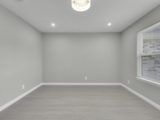 2834 Sunny Hill Ln, Farmers Branch, TX 75234 - spare room featuring wood finished floors, a chandelier, baseboards, and recessed lighting