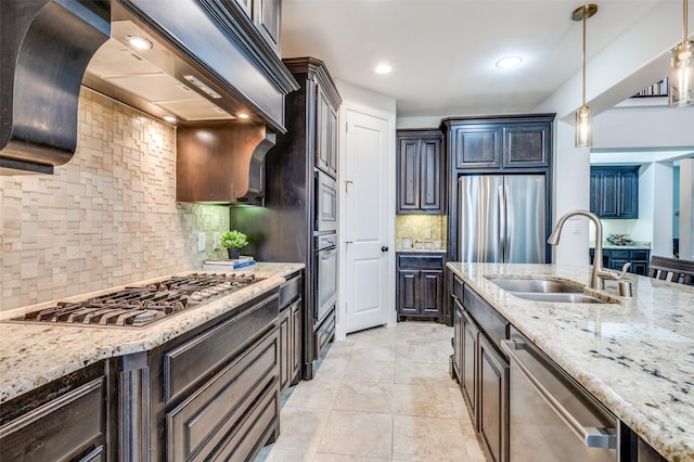 kitchen featuring a sink, stainless steel appliances, custom range hood, tasteful backsplash, and light stone countertops