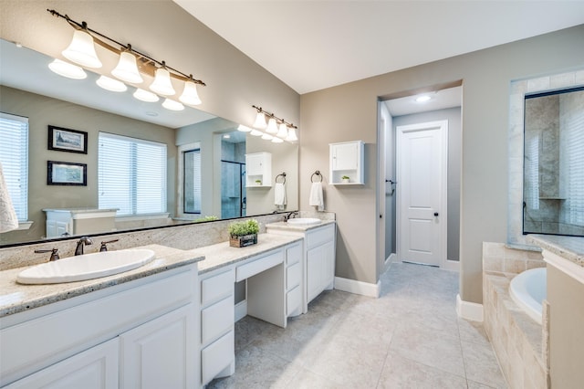 bathroom with double vanity, a bath, and tile patterned floors