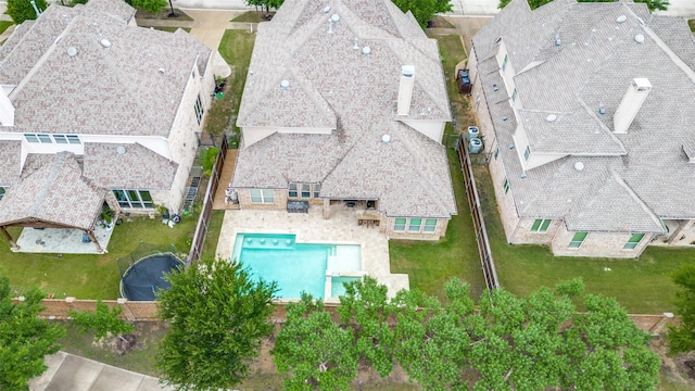 aerial perspective of suburban area featuring a pool area