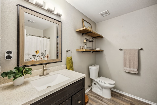 605 Preston Dr, Royse City, TX 75189 - bathroom with vanity, wood finished floors, toilet, and baseboards